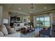 Staged living room, featuring open floor plan and lake views through large window at 1027 Ocean Spray Dr, Ruskin, FL 33570