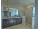 Main bathroom featuring double vanity, granite countertops, and glass shower at 1027 Ocean Spray Dr, Ruskin, FL 33570