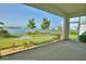 Screened patio overlooking manicured lawn and tranquil lake views at 1027 Ocean Spray Dr, Ruskin, FL 33570
