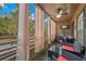 Inviting outdoor balcony with comfortable seating, curtains for privacy, and a scenic view at 104 Cypress Pond Rd, Palm Harbor, FL 34683