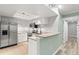 Bright kitchen with white cabinets, stainless steel appliances, and granite countertops at 104 Cypress Pond Rd, Palm Harbor, FL 34683