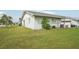 Single story home with grassy lawn and shrubs at 1301 New Bedford Dr # 1301, Sun City Center, FL 33573