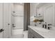 Bathroom with gray vanity, white bathtub, and mosaic tile accents at 13811 Sharp Hawk Dr, Riverview, FL 33569