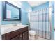 Clean bathroom with a shower/tub combo, vanity, and light blue walls at 1504 Ringmore Ct, Dover, FL 33527