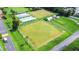 Aerial view of community lawn bowling area with well maintained greens and covered seating at 2104 Hembury Pl # 33, Sun City Center, FL 33573