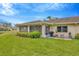 Well-maintained backyard featuring a patio area, lush landscaping, and plenty of green space at 2104 Hembury Pl # 33, Sun City Center, FL 33573