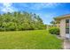 Expansive backyard with lush green lawn and view of the adjacent canal providing a tranquil setting at 2104 Hembury Pl # 33, Sun City Center, FL 33573