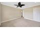 A large, carpeted bedroom features a ceiling fan and access to an ensuite bathroom at 2104 Hembury Pl # 33, Sun City Center, FL 33573