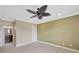 Spacious bedroom features a ceiling fan and adjoins a bathroom at 2104 Hembury Pl # 33, Sun City Center, FL 33573