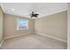This carpeted bedroom has a window view and neutral color scheme at 2104 Hembury Pl # 33, Sun City Center, FL 33573