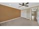 Cozy bedroom with neutral carpeting, a ceiling fan, and a spacious closet at 2104 Hembury Pl # 33, Sun City Center, FL 33573