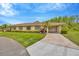 Charming single story home with a well maintained lawn, mature landscaping, and a two-car carport at 2104 Hembury Pl # 33, Sun City Center, FL 33573