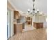Open kitchen featuring stainless steel appliances, a stone counter-top island, and wood cabinets at 2104 Hembury Pl # 33, Sun City Center, FL 33573