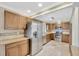 Charming kitchen with wooden cabinets, granite countertops, and stainless steel appliances at 2104 Hembury Pl # 33, Sun City Center, FL 33573