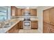 This kitchen features wooden cabinets, granite countertops, and stainless steel appliances at 2104 Hembury Pl # 33, Sun City Center, FL 33573