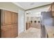Spacious kitchen featuring wooden cabinetry, granite countertops, and stainless steel refrigerator at 2104 Hembury Pl # 33, Sun City Center, FL 33573
