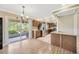 Open kitchen with stainless steel appliances, wood cabinets, and sliding glass doors to the lanai at 2104 Hembury Pl # 33, Sun City Center, FL 33573