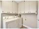 Laundry room features a washer, dryer, and overhead cabinets for extra storage at 2104 Hembury Pl # 33, Sun City Center, FL 33573