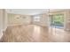 Bright and open living room with hardwood floors and sliding glass doors to the screened in lanai at 2104 Hembury Pl # 33, Sun City Center, FL 33573