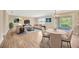Stylishly furnished living room with hardwood floors, dining area, and sliding glass doors to the lanai at 2104 Hembury Pl # 33, Sun City Center, FL 33573