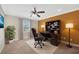 Home office featuring a desk with built in shelves, a large window, and a comfortable chair at 2104 Hembury Pl # 33, Sun City Center, FL 33573