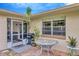 Cozy patio with a dining table, grill, and screened in porch, perfect for outdoor entertaining at 2104 Hembury Pl # 33, Sun City Center, FL 33573
