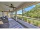 Enclosed patio featuring two ceiling fans, three wicker chairs, and views of the green backyard at 2104 Hembury Pl # 33, Sun City Center, FL 33573