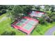 An aerial view of well-maintained tennis courts, bordered by tall trees, offering residents a place for sport and exercise at 2104 Hembury Pl # 33, Sun City Center, FL 33573