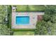 Overhead view of community pool with surrounding patio furniture at 3551 Magnolia Ridge Cir # 702, Palm Harbor, FL 34684