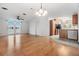 Open living room and kitchen area with light wood flooring throughout at 37449 Gill Ave, Zephyrhills, FL 33541
