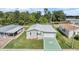 Single-story home with attached garage and a green star-shaped driveway at 37449 Gill Ave, Zephyrhills, FL 33541