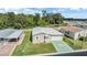 Single-story home with attached garage and a green star-shaped driveway at 37449 Gill Ave, Zephyrhills, FL 33541