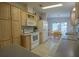 Bright kitchen with light wood cabinets and white appliances at 37449 Gill Ave, Zephyrhills, FL 33541