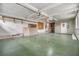 Garage with high ceilings, storage, and exterior access at 37449 Gill Ave, Zephyrhills, FL 33541
