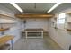 Workshop area with built-in shelving and workbench at 37449 Gill Ave, Zephyrhills, FL 33541