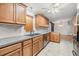Kitchen with wood cabinets, stainless steel appliances, and a tile floor at 37449 Gill Ave, Zephyrhills, FL 33541