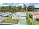 Single-story home with attached garage and a green star-shaped driveway at 37449 Gill Ave, Zephyrhills, FL 33541