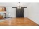 Bright dining room features a wood sliding barn door and light wood flooring at 37449 Gill Ave, Zephyrhills, FL 33541