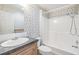 Bathroom with shower/tub combo and patterned wallpaper at 37449 Gill Ave, Zephyrhills, FL 33541