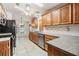 Classic kitchen with wood cabinets, tile backsplash, and stainless steel appliances at 37449 Gill Ave, Zephyrhills, FL 33541