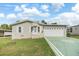 Single-Gathering home with a large driveway and well-maintained yard at 37449 Gill Ave, Zephyrhills, FL 33541