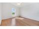 Simple bedroom with light wood flooring and a window with a view at 37449 Gill Ave, Zephyrhills, FL 33541