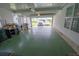 Two-car garage with green epoxy flooring and storage shelves at 37449 Gill Ave, Zephyrhills, FL 33541