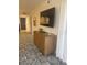 Long hallway with wood dresser and blue patterned rug at 4774 Fox Hunt Dr # C115 &C113, Wesley Chapel, FL 33543