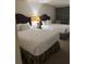 Two twin beds in a well lit bedroom with dark wood headboards at 4774 Fox Hunt Dr # C115 &C113, Wesley Chapel, FL 33543