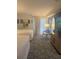 Bedroom with two beds, a chair, and access to a balcony at 4774 Fox Hunt Dr # C115 &C113, Wesley Chapel, FL 33543