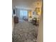 Open living area with sectional sofa, coffee table, and patterned rug at 4774 Fox Hunt Dr # C115 &C113, Wesley Chapel, FL 33543