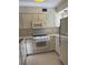 Condo kitchen with white cabinets and appliances at 4774 Fox Hunt Dr # C115 &C113, Wesley Chapel, FL 33543