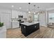 Modern kitchen with white cabinets, quartz countertops, and a large island at 7672 Tuscan Bay Cir, Wesley Chapel, FL 33545