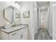 Modern bathroom with granite countertop and octagon mirror at 8192 Ivy Stark Blvd, Wesley Chapel, FL 33545